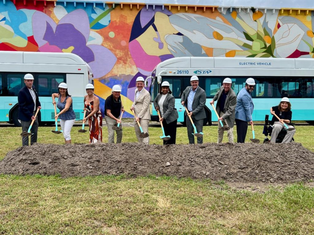 Clearwater Station groundbreaking. People in front of bus holding shovels of dirt 