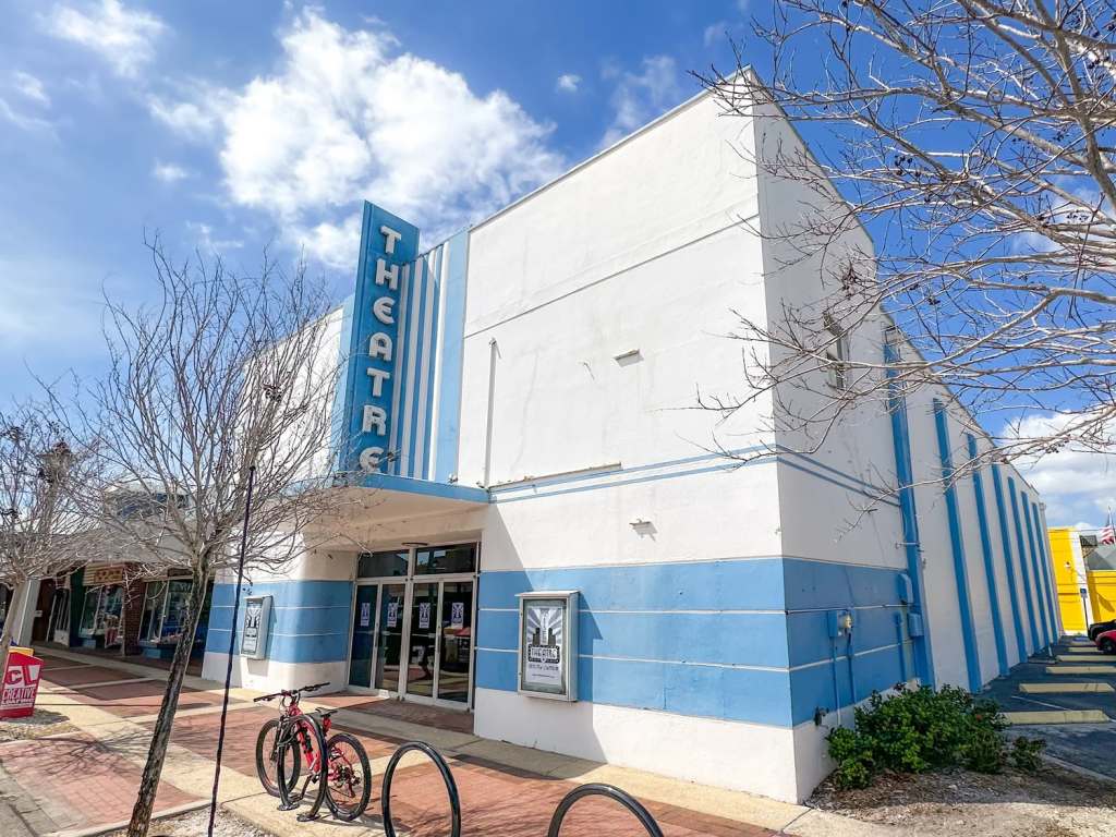 A photo of a blue and white building with a vertical sign on its front that read "Theater"; this is The Beach Theater in St. Pete Beach